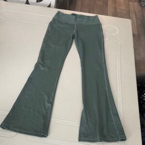 Kids Flared Green Leggings with slits at ankle.